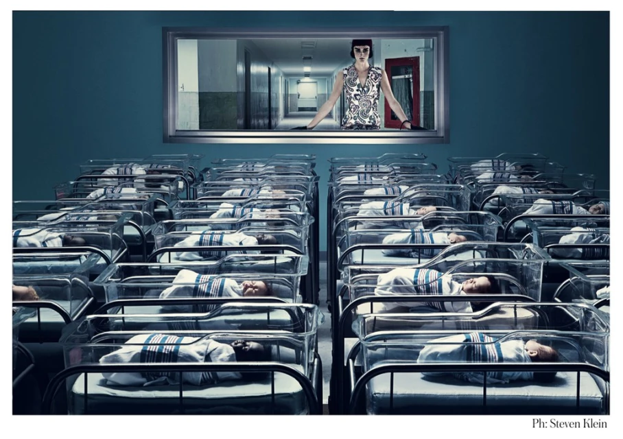 Stylized image of newborn babies in cribs in rows, with a woman in a window overlooking them in a hospital setting.