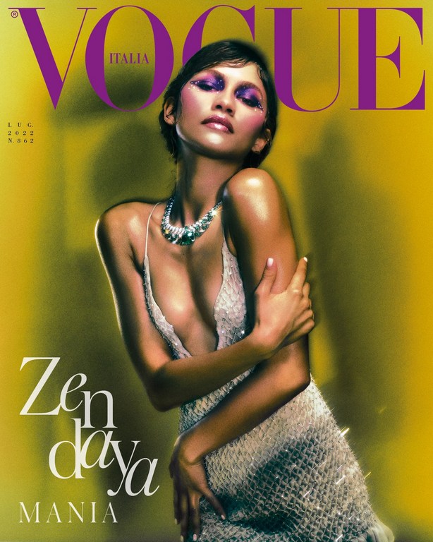 Vogue Italia cover featuring Zendaya wearing a sparkling dress and necklace, posing against a blurred yellow background.