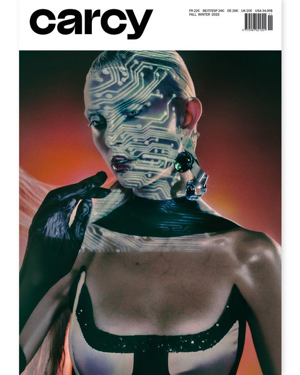 Magazine cover featuring a woman with a circuit board pattern projected onto her face, wearing jewelry and a black-and-white top.