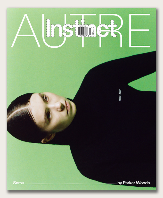 Magazine cover featuring a person with slicked-back hair wearing a black turtleneck against a light green background with white text.