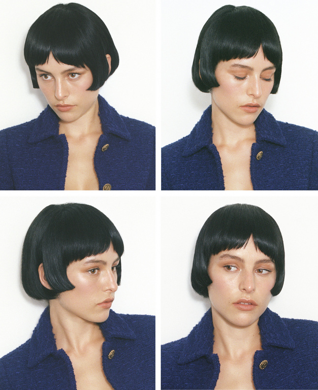 Headshot portrait mosaic of a woman with a short, blunt bob haircut, wearing a navy blue textured jacket against a white backdrop.