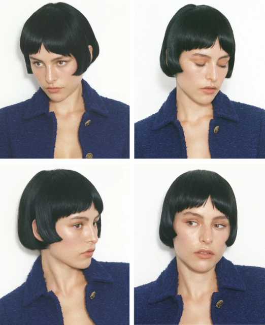 Headshot portrait mosaic of a woman with a short, blunt bob haircut, wearing a navy blue textured jacket against a white backdrop.