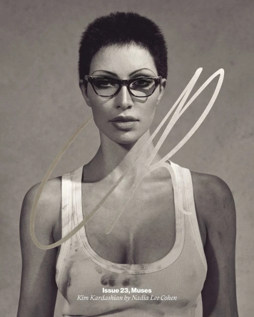Black and white portrait of Kim Kardashian wearing glasses and a tank top for a magazine cover, shot in a photo studio.
