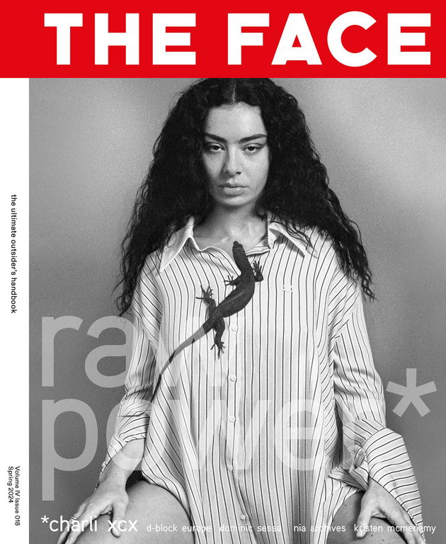 Black and white magazine cover featuring a person with dark curly hair wearing a striped shirt with a lizard, set against a grey background.