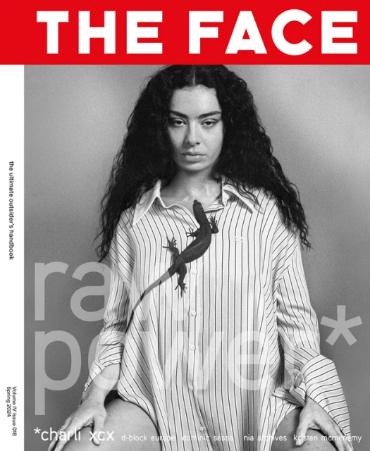 Black and white magazine cover featuring a person with dark curly hair wearing a striped shirt with a lizard, set against a grey background.