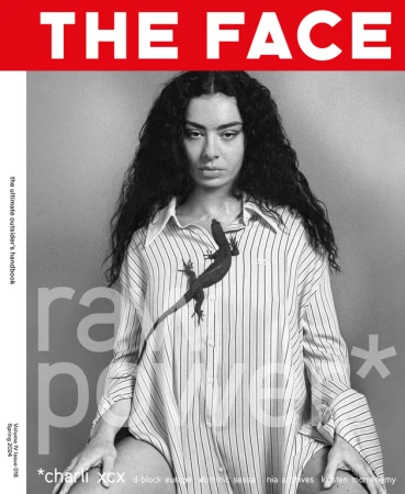 Black and white magazine cover featuring a person with dark curly hair wearing a striped shirt with a lizard, set against a grey background.