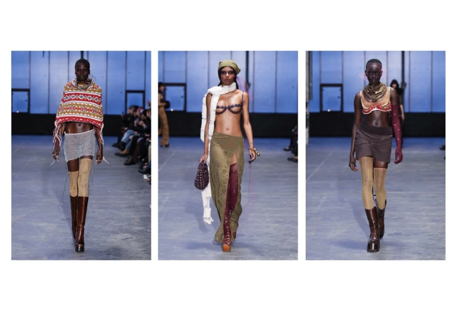 Runway models showcasing avant-garde fashion with sheer tops, skirts, and knee-high boots, against a blue background with a seated audience.