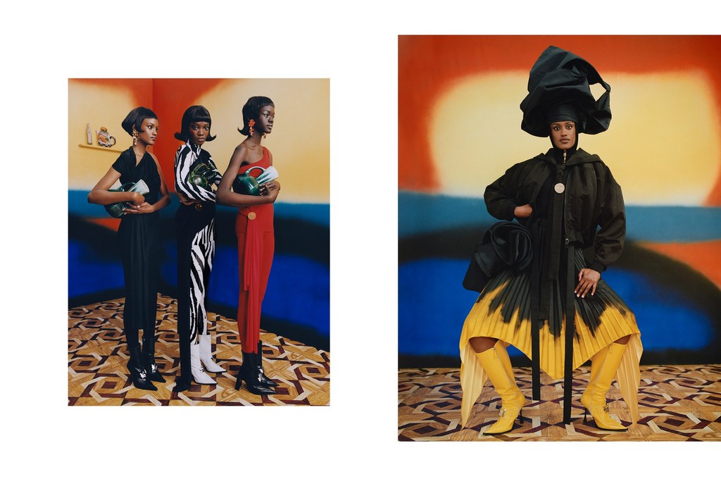 Three fashion models stand in a studio in various color dresses holding handbags, and a solo model sits in front of a painted canvas.