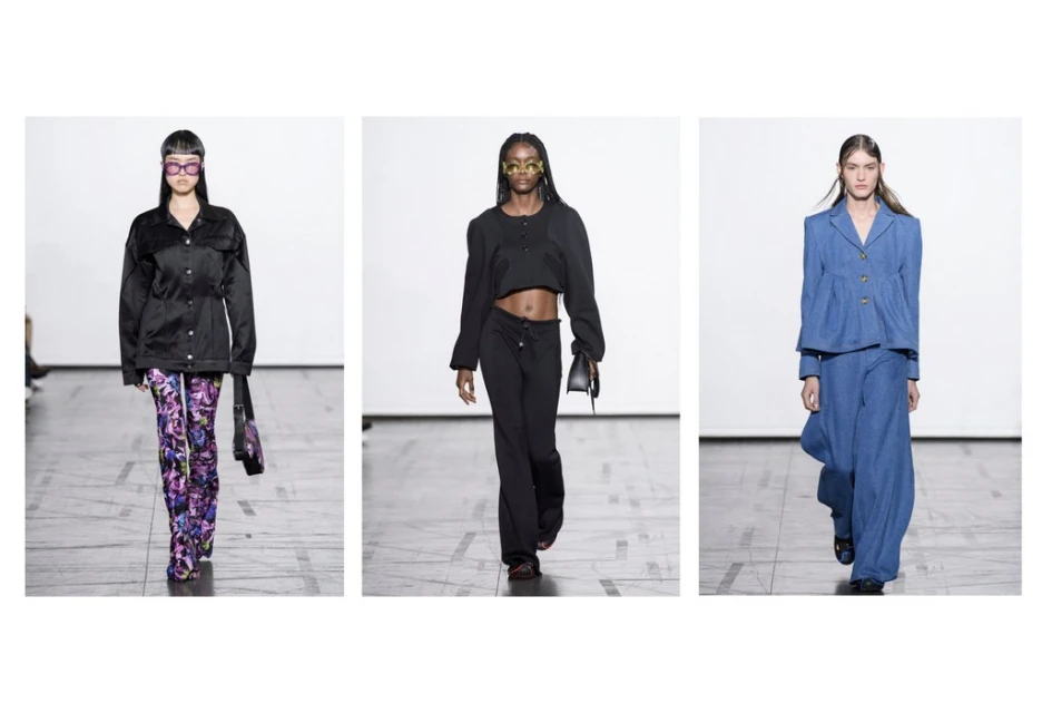 Three fashion models showcase runway looks: a black jacket with floral pants, a cropped black top and pants, and a blue denim suit.