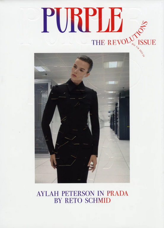 Magazine cover featuring a woman in a black dress, standing in a computer server room with the title 'Purple: The Revolutions Issue'.