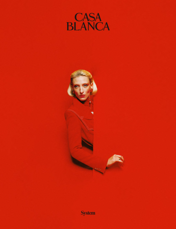 A blonde woman in a red jacket emerging from a matching red background with the text CASA BLANCA visible above.