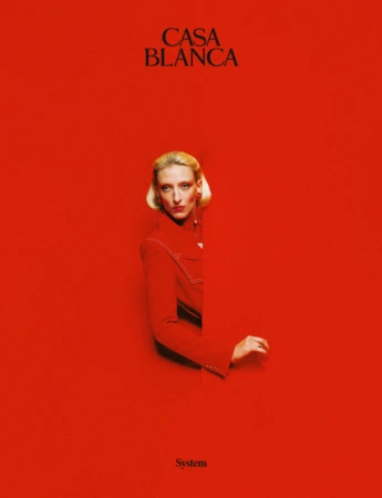 A blonde woman in a red jacket emerging from a matching red background with the text CASA BLANCA visible above.