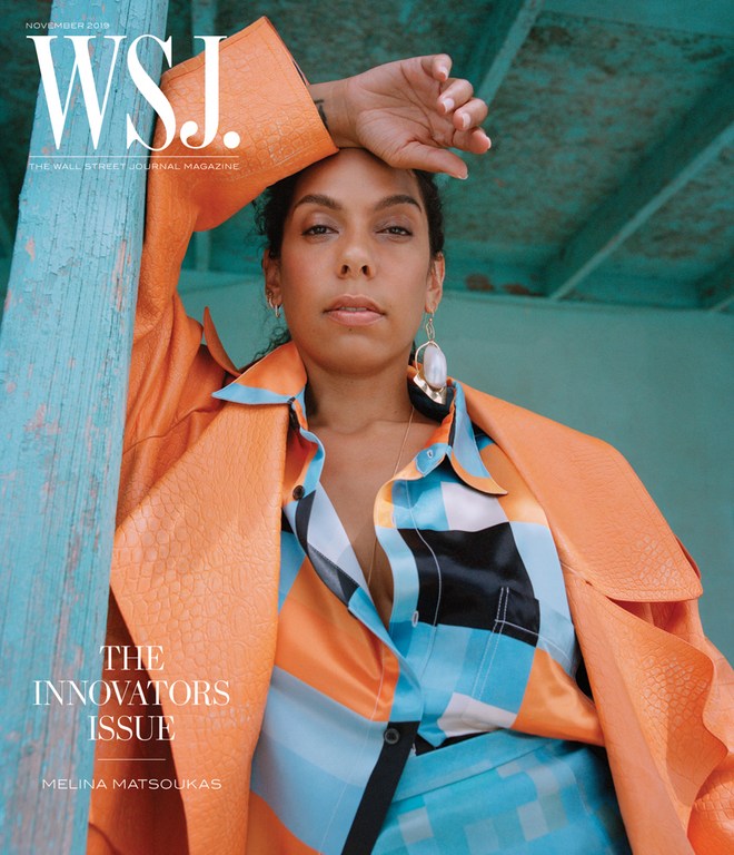 WSJ Magazine cover featuring Melina Matsoukas in an orange coat and patterned shirt against a teal background, posing with hand on head.