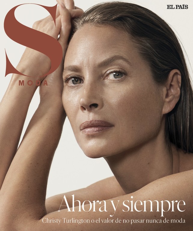Close-up studio portrait of a mature woman with natural makeup and hands near her face, shot for a magazine cover with visible masthead.