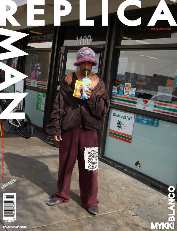 Magazine cover of a man in casual clothing standing outside a 7-Eleven convenience store, holding a drink, with magazine text overlay.