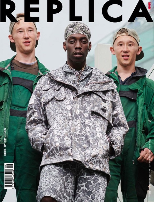 Replica Man magazine cover featuring a Black male model in a grey camouflage jacket with two white male models in green workwear.