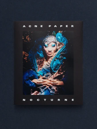 Cover of Acne Paper Nocturne featuring an ornate editorial portrait with blue makeup and sculptural headpiece.