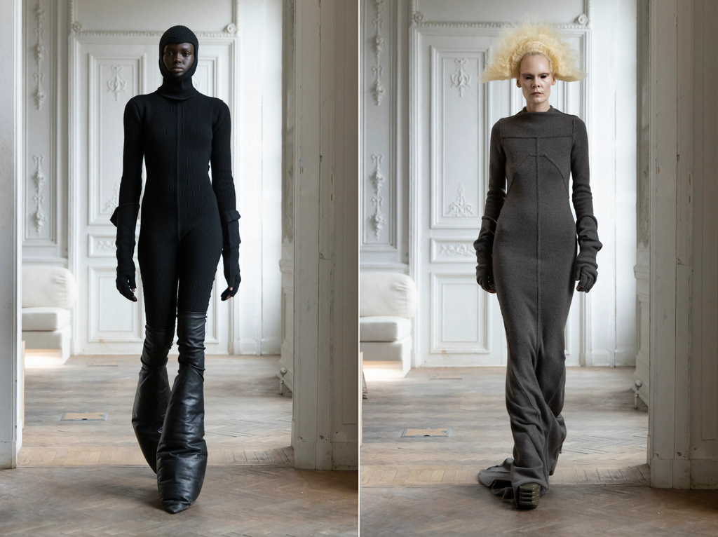 Two models present avant-garde fashion in a studio. One in black bodysuit and cone-shaped boots, the other in a grey dress.