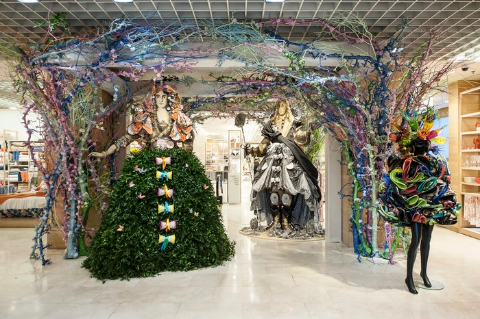 Elaborate retail display installation featuring sculptural mannequins and intertwined branches by Simon Costin