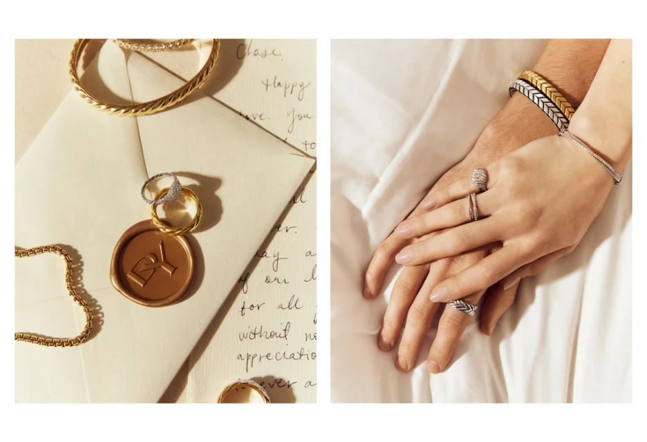 Close-up studio shot of gold rings, bracelets, and a wax-sealed envelope on a white surface, next to a man and woman's intertwined hands adorned with jewelry.