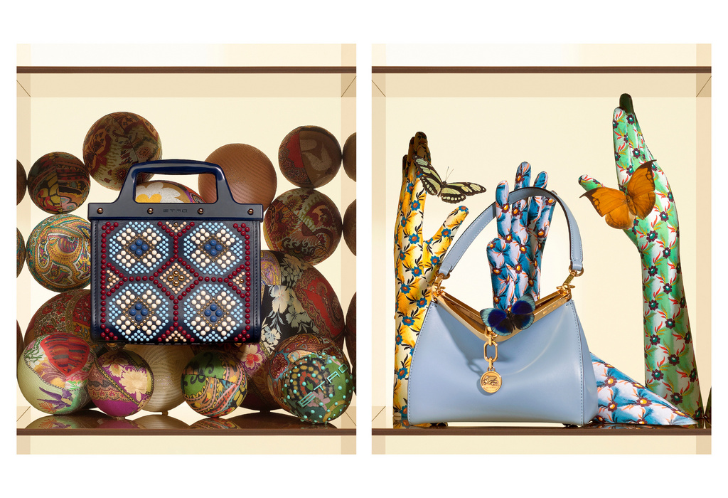 Two handbags are displayed in individual compartments, one embellished with geometric designs and the other with floral-patterned hand props.