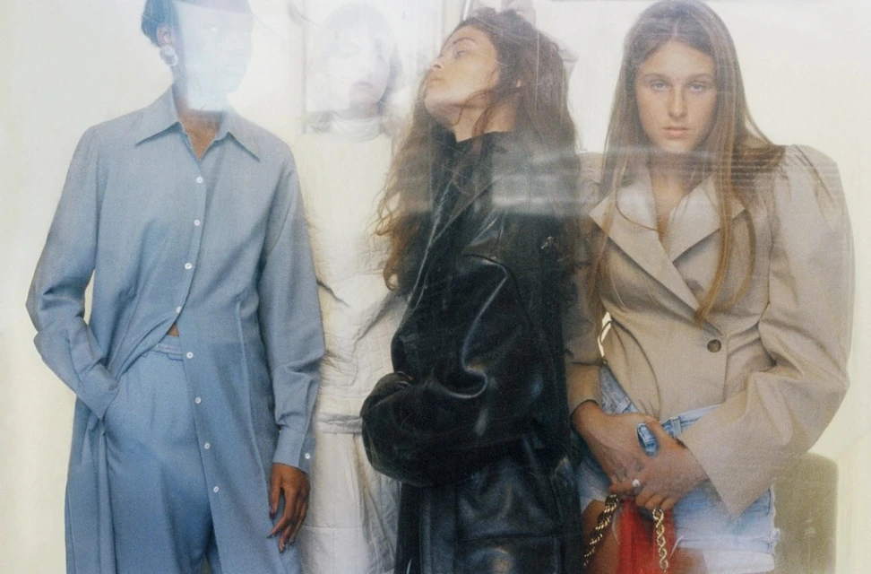 Fashion editorial featuring four women in stylish outfits; a blue shirt-pant set, a black leather jacket, and a beige blazer with denim shorts.