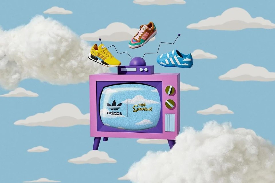 Retro television displaying Adidas and The Simpsons logo with three Adidas sneakers floating above, set against a cloudy sky backdrop.