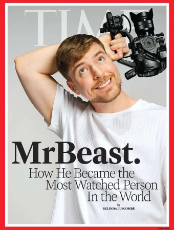 Magazine cover featuring a smiling man holding a professional video camera, the cover reads: 'MrBeast. How He Became the Most Watched Person'.