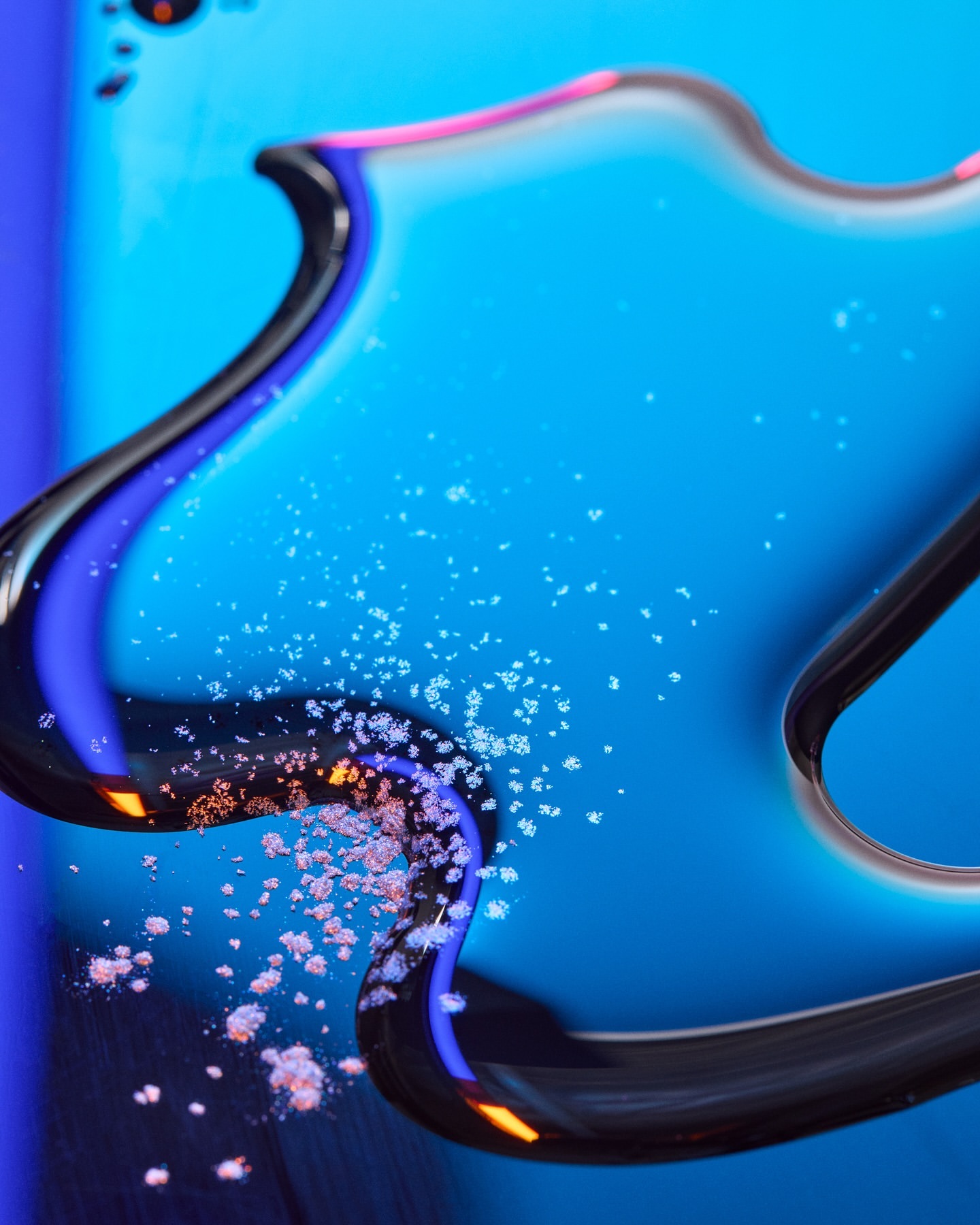Abstract close-up of a smartphone with a blue screen and reflective curved edges, featuring scattered white powder.