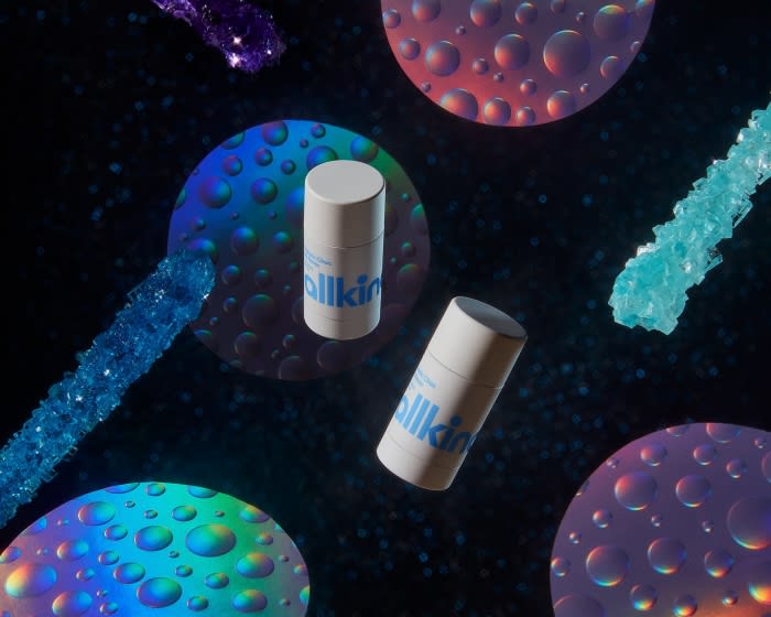 Allkin brand deodorant sticks surrounded by iridescent orbs and sparkling crystal sticks against a dark, stellar backdrop.