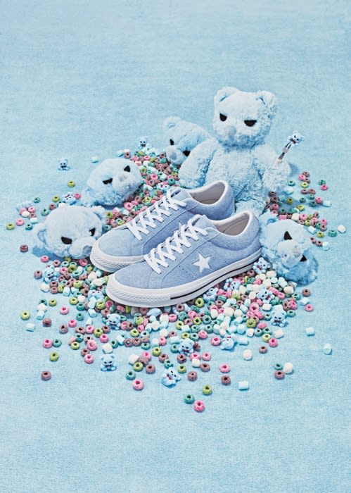 Light blue One Star Converse sneakers surrounded by a whimsical arrangement of teddy bears and pastel-colored donut-shaped cereal pieces.