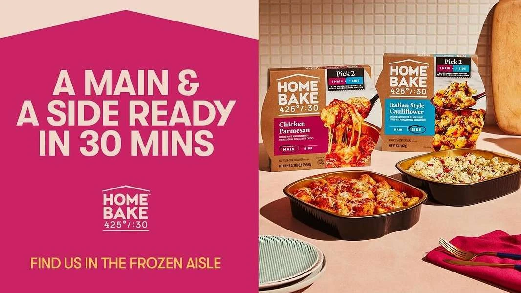 Home Bake frozen meals in packaging and cooked in dishes on a table, featuring chicken parmesan and Italian style cauliflower.