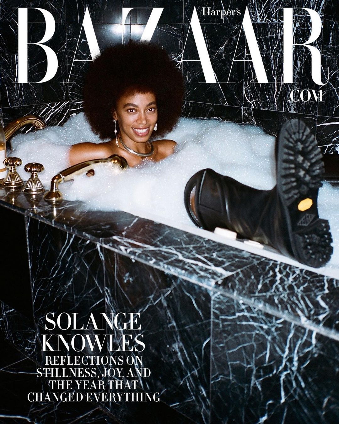 Fashion editorial featuring Solange Knowles in a marble bathtub filled with bubbles, Harper's Bazaar cover, with black work boots.