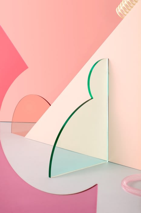 Geometric abstract in pastel pinks: glossy green-edged acrylic sheet contrasts with arched pink shapes against a pastel background.