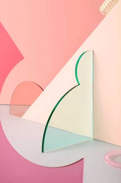 Geometric abstract in pastel pinks: glossy green-edged acrylic sheet contrasts with arched pink shapes against a pastel background.