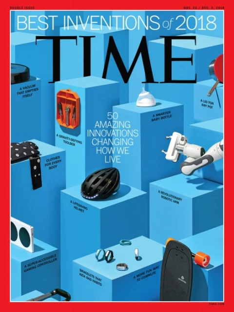Time Magazine cover showcasing the best inventions of 2018. Blue blocks display items: robotic arm, helmet, baby bottle, skateboard, and other inventions.