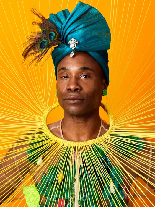 Portrait of a Black man in avant-garde fashion featuring a turquoise turban with peacock feathers and a green and yellow statement collar.