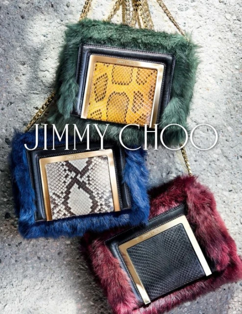 Three Jimmy Choo fur and snakeskin handbags with gold chain straps are displayed against a neutral concrete background.