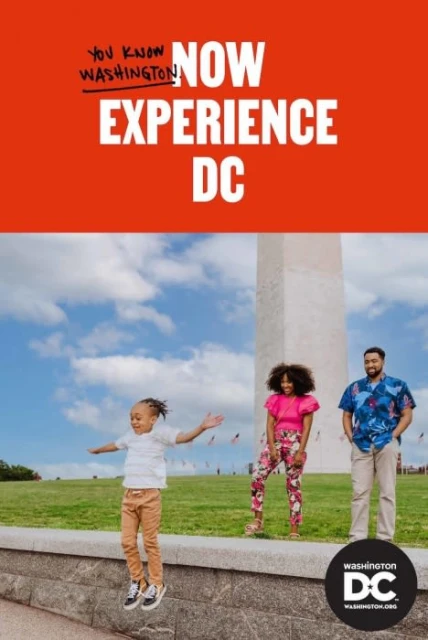 A family of three posing in front of the Washington Monument. A child jumps off a short wall. "Experience DC" text on top.