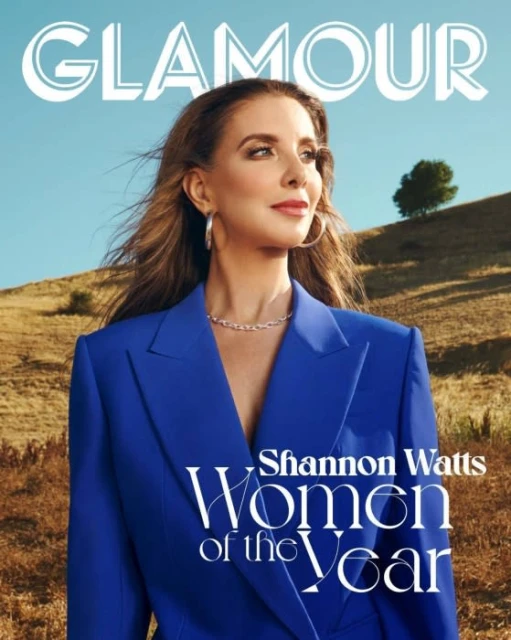 Glamour magazine cover featuring Shannon Watts. The shot is outdoors, with Watts wearing a blue suit jacket and jewelry.