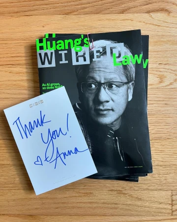 Wired magazine cover featuring Jensen Huang with a thank you note, and paperclip on a light brown wooden surface.