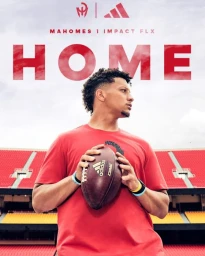 Patrick Mahomes holding a football wearing a red t-shirt in front of stadium seats with large HOME text above him