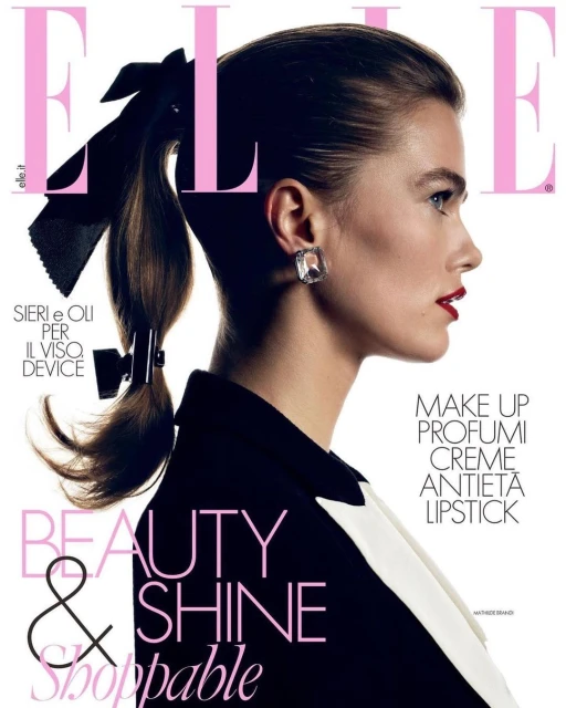 Elle magazine cover featuring a model in a black jacket with a white collar, side profile, wearing a bow and statement earrings.