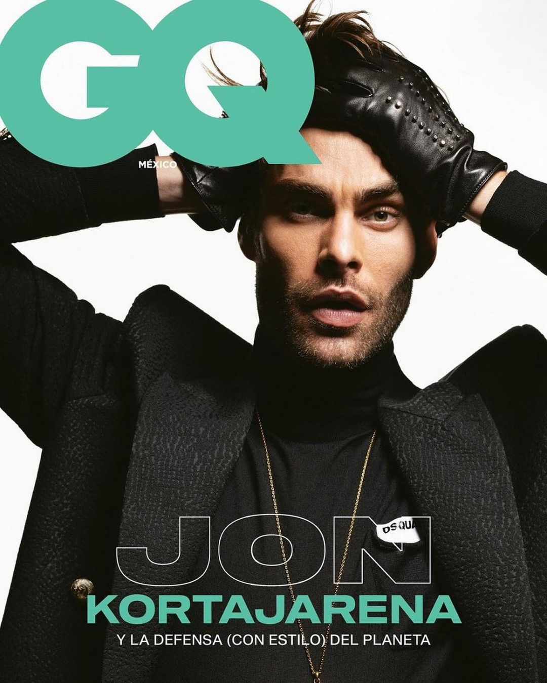 GQ cover featuring Jon Kortajarena. The model poses in a black turtleneck and coat, wearing leather gloves, with GQ logo in the corner.