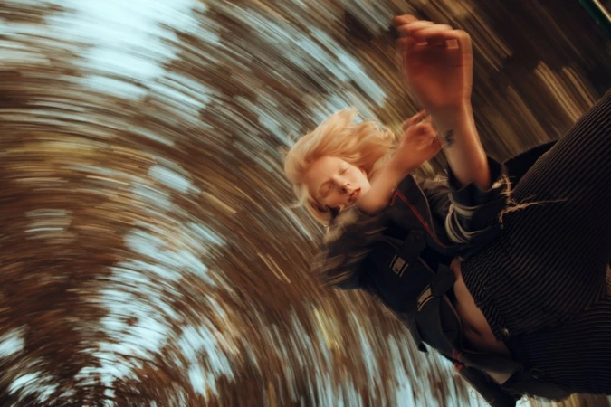 Portrait of a blonde woman with motion blur against a swirling radial background captured by Alessio Albi