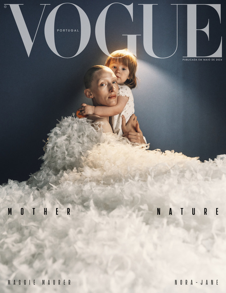Vogue Portugal magazine cover featuring a child hugging an adult with white feathery garment against a dark backdrop. Fashion editorial.