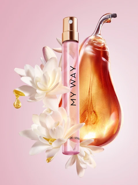 Still life of Giorgio Armani's 'My Way' perfume bottle surrounded by white flowers, golden liquid pear sculpture on light pink background.