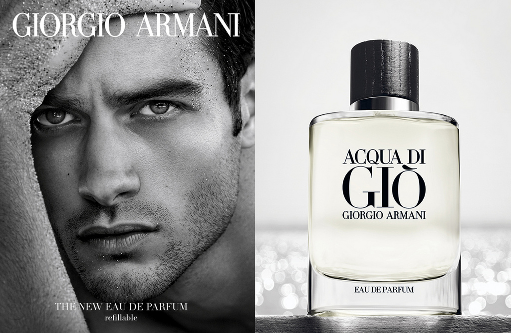 Fragrance advertisement featuring a man's face in black and white beside a clear Giorgio Armani Acqua Di Gio perfume bottle.