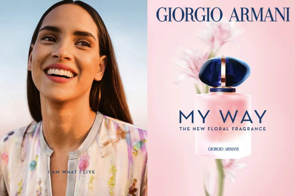 An ad for Giorgio Armani's 'My Way' perfume features a smiling woman and a bottle of the fragrance against a pink floral backdrop.