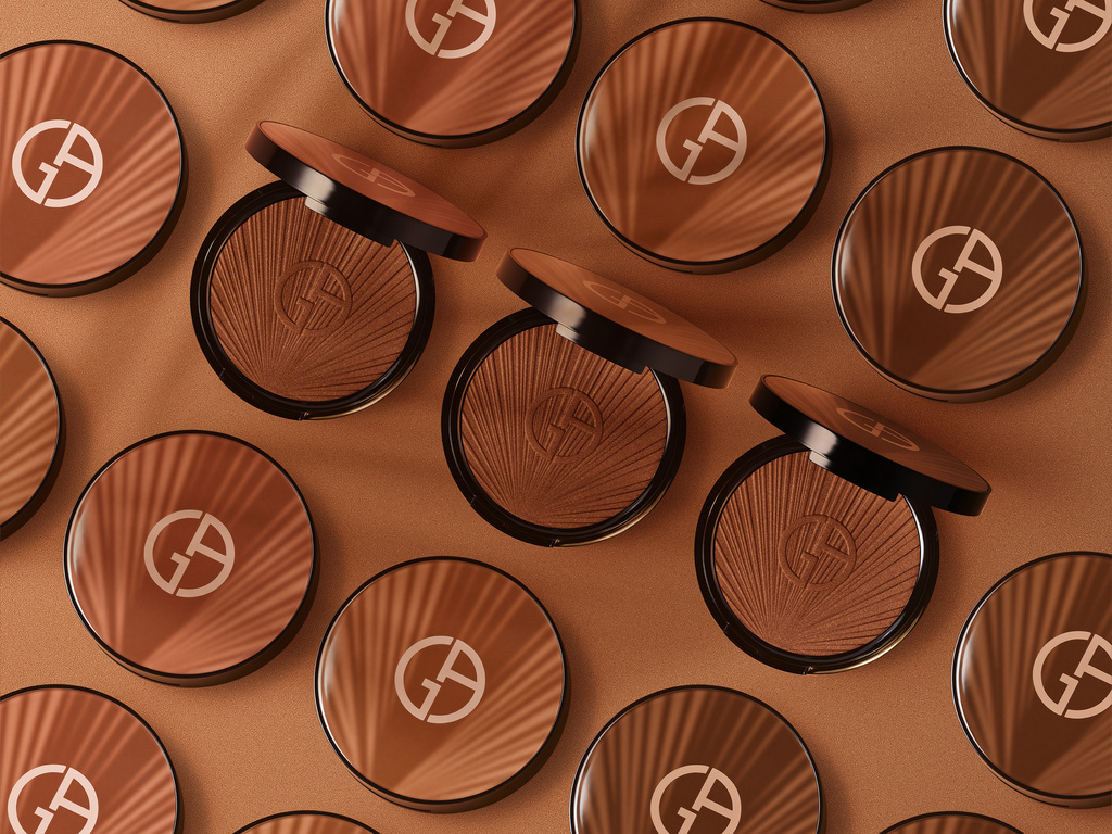 Overhead shot showcasing Giorgio Armani bronzing powders in warm tones on a matching background, highlighting beauty and cosmetics.